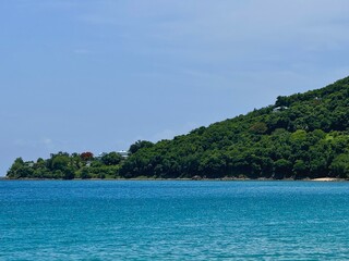 landscape of a coast of Guadeloupe in the French Antilles with a view of the Caribbean Sea and a mountain with tropical vegetation
