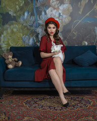 A girl in a red outfit on the couch