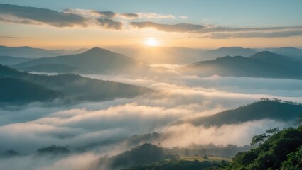 Obraz premium Capture the beauty of a serene sunrise over misty mountains, where gentle, golden sunlight softly illuminates the valleys below. This image reflects the tranquility of nature and the breath.