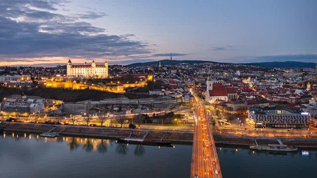 Day to night aerial time lapse Bratislava old town and castle, view from SNP bridge. Slovakia.