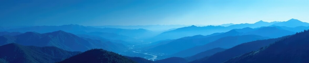 Obraz premium vast open landscape of rolling hills and mountains in a deep blue atmosphere, scenery, peaceful, atmospheric