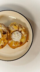 Donuts with Almond and Cream topping that put on the plate