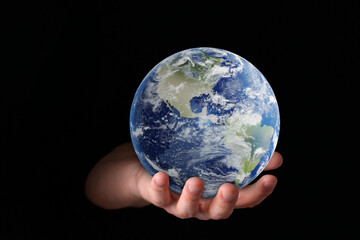 Planet in our hands. Man holding Earth model on black background, closeup
