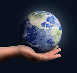Planet in our hands. Woman holding glowing Earth on dark blue background, closeup