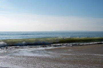 wave crashing onto a beautiful deserted beach at Hengistbury Head Dorset England