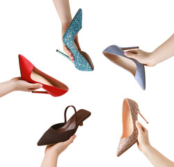 Women holding different shoes on white background, closeup