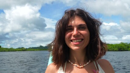 Female tourist experiencing vibrant maritime adventure on traditional philippine outrigger, enjoying serene ocean scenery with carefree excitement and joy