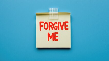 Note paper stuck on a blue background with the message FORGIVE ME, intended to request forgiveness and to be courteous before making a rude or offensive remark.