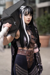 Naklejka premium Pretty female cosplayer dressed as an Anime warrior with sword