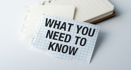 A torn piece of paper with the words What you need to Know written on it