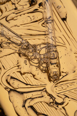 Pipettes with golden parts serum, anti-aging concept on golden tray