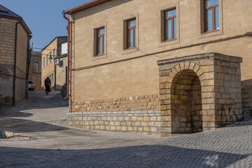 Ancient quarters of the city of Derbent. The private sector in the ancient city. The streets in the old quarters are paved with paving stones. Ancient sandstone houses. Narrow ancient streets.
