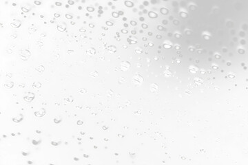 Water droplets on dark surface, macro view.