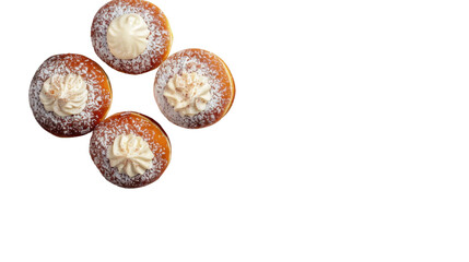 Four donuts floating on transparent background, topped with cream and powdered sugar
