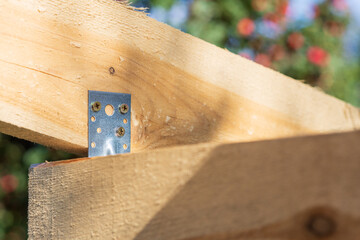A wooden beam with a metal bracket on it