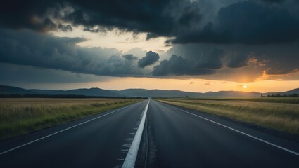 Fototapeta premium Straight asphalt highway with a mountain nature backdrop during sunset.