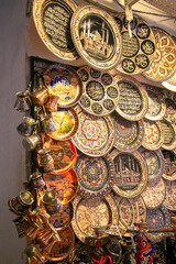 Handmade painted plates are sold in the Turkish market. Souvenir Plates and Turks for Coffee in Istanbul Market