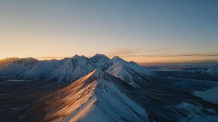 Aerial View of Snow-Capped Mountains at Sunrise with Breathtaking Landscape