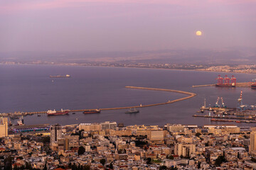 Haifa, Israel – March 7, 2025, Twilight view of the lower city and port from Louis Promenade with...