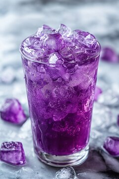 Refreshing purple elixir with ice cubes in a glass on a cool marble surface capturing a vibrant and inviting summer mood from a high angle