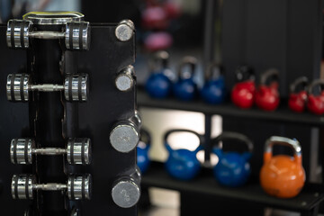 A pair of dumbbells neatly arranged in the gym, ready for a powerful workout session to build...