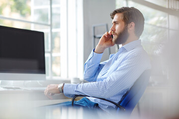 Man, architect and phone call in office, talking and online for negotiation on development....