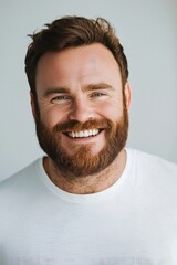 Fototapeta premium Happy Man with Red Beard Smiling in White T-Shirt