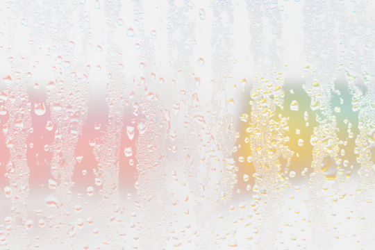 Condensation on glass with colorful blurred background.