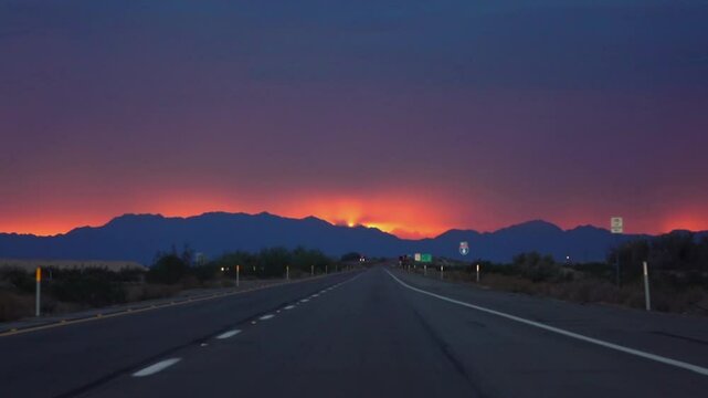 Driving on a road to Yuma, Arizona with a vibrant sunset in slow motion 120fps