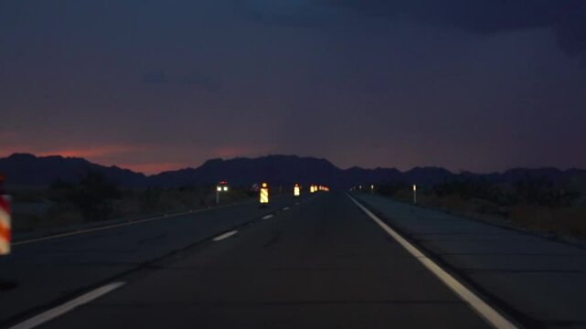 Driving at night on the road to Yuma, Arizona with road construction signs in slow motion 120fps