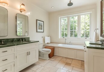 Spacious and Elegant Modern Bathroom with Natural Light, Bathtub, White Cabinets, Green Marble Countertops, and Stylish Fixtures in a Cozy Home Setting