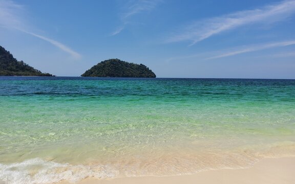 tropical beach with turquoise water and blue sky