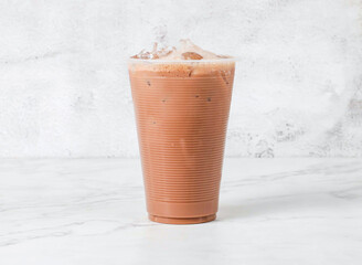 Iced Milo Chocolate Tea served in plastic cup isolated on marble background side view of Singapore beverage