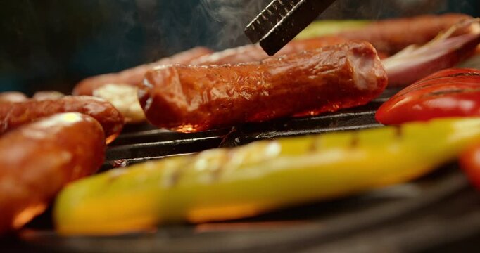 Ultra slow-motion shot of meet sausages getting cooked on the barbeque grill. Close-up footage