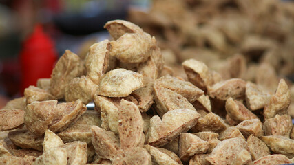 Selective focus of Indonesian Food, Bakso Goreng (Deep Fried Meat Balls). The shape look like flower. Served with Chili sauce.