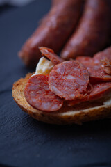 Sliced chorizo on toasted bread.