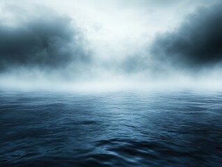 Fototapeta premium Serene expanse of dark blue ocean waters under a misty sky with dramatic clouds creating a moody and atmospheric seascape for stock photography