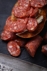 Sliced chorizo on toasted bread.