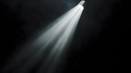 Dramatic Bright White Light Beam Illuminating Through Dark Smoke Filled Atmosphere in Black Background