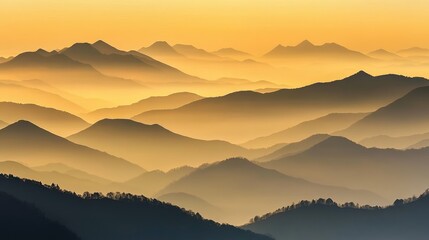 Hazy mountain peaks stretching across the horizon under a golden sunrise.