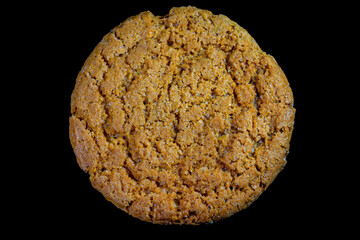 A singular cookie commonly known as a ginger snap. It is comprised of flour, sugar, oil, and flavored with powdered ginger and a variety of other spices, most commonly cinnamon, molasses and cloves.