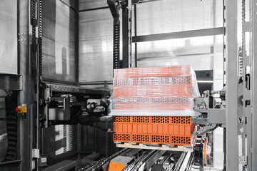 Automated brick production conveyor packing with stretch film