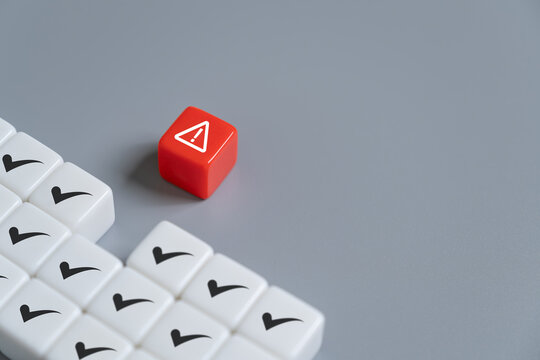 close up at the red cube to identify red danger risk cube among other normal incident. Risk management concept for business and personal planning for risk mitigation.