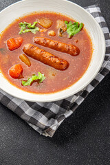 Tomato soup with sausages fresh tasty food dish delicious gourmet food background on the table rustic food top view copy space