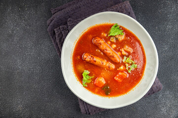 Tomato soup with sausages fresh tasty food dish delicious gourmet food background on the table rustic food top view copy space