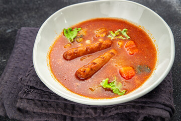 Tomato soup with sausages fresh tasty food dish delicious gourmet food background on the table rustic food top view copy space