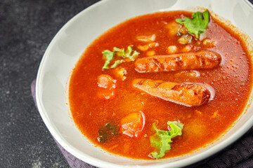 Tomato soup with sausages fresh tasty food dish delicious gourmet food background on the table rustic food top view copy space