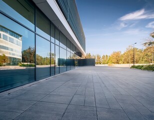 an empty parking area outside an elegant modern architectural building with large glass windows