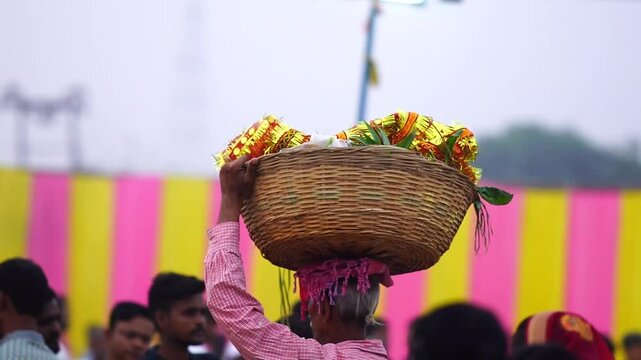 an indina man carrying a chhat pooja dala on head