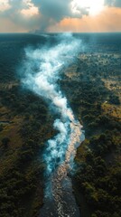 Aerial View of River with Smoke Plume Over Lush Green Landscape